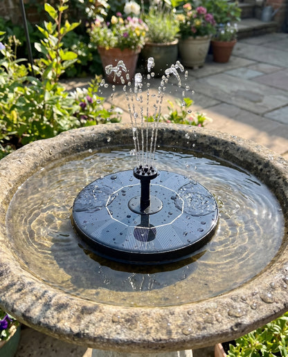 Solar fountain running in a stone bird bath